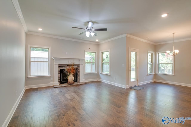 unfurnished living room featuring a wealth of natural light, dark hardwood / wood-style flooring, and ornamental molding