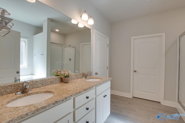 bathroom featuring vanity and a shower with door