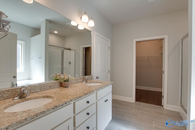 bathroom featuring vanity and an enclosed shower