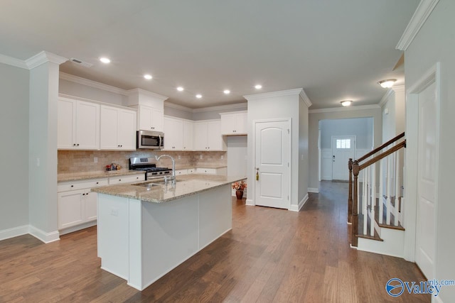 kitchen featuring white cabinets, appliances with stainless steel finishes, and dark hardwood / wood-style flooring