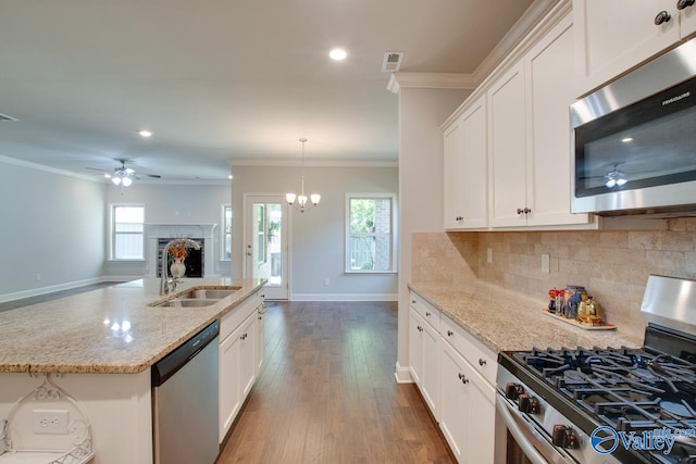 kitchen with white cabinets, appliances with stainless steel finishes, dark hardwood / wood-style floors, and sink