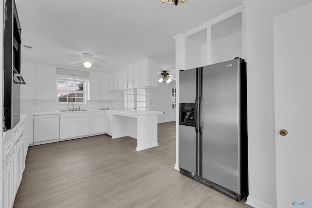 kitchen featuring white dishwasher, stainless steel refrigerator with ice dispenser, a sink, and a ceiling fan