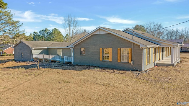 back of house featuring brick siding