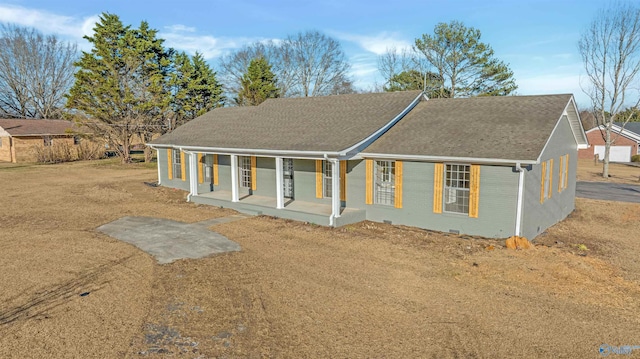 view of front of property featuring covered porch, a shingled roof, and brick siding