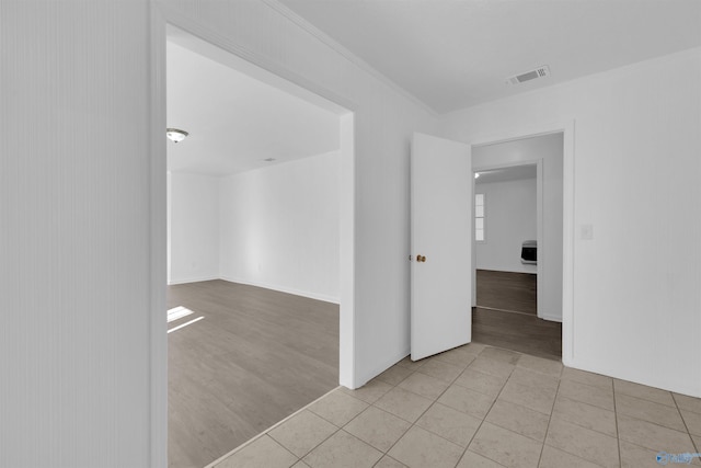 tiled spare room featuring visible vents