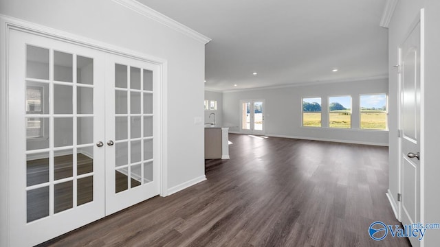 empty room with dark hardwood / wood-style flooring, a healthy amount of sunlight, french doors, and ornamental molding