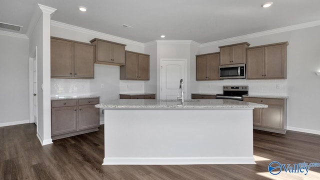 kitchen featuring ornamental molding, stainless steel appliances, dark hardwood / wood-style floors, sink, and a kitchen island with sink