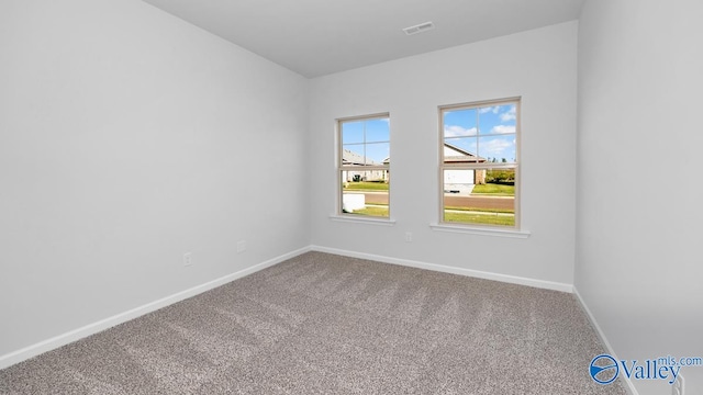 unfurnished room featuring carpet