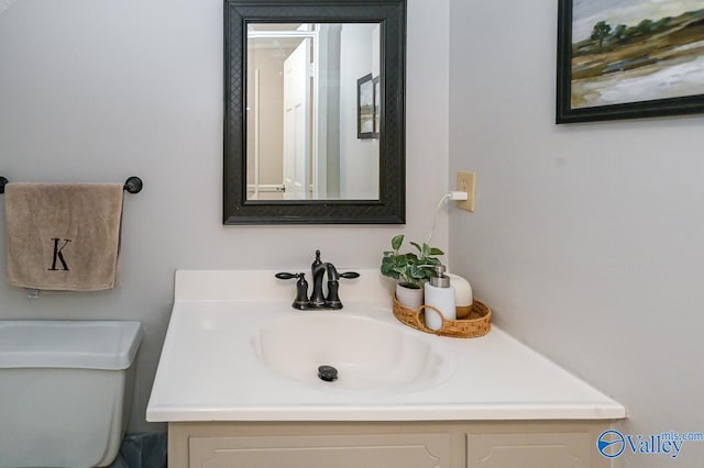 bathroom with toilet and vanity