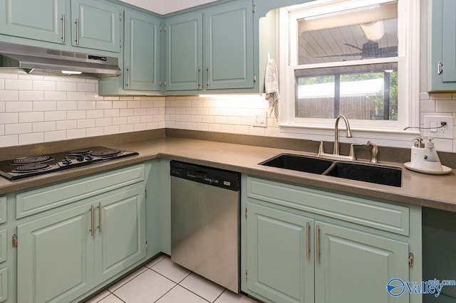 kitchen with backsplash, dishwasher, light tile patterned floors, sink, and gas stovetop