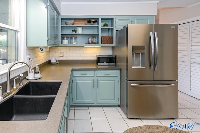 kitchen with appliances with stainless steel finishes, sink, crown molding, and decorative backsplash