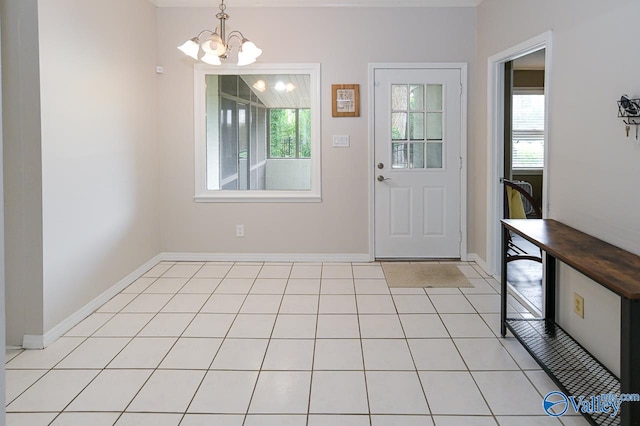 tiled foyer featuring a chandelier