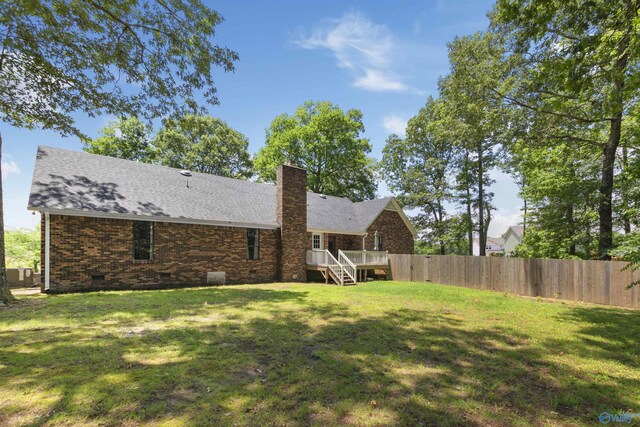 view of yard with a deck and fence
