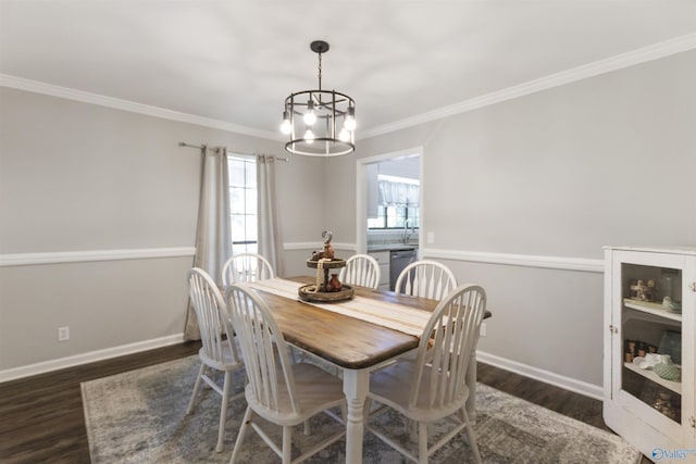 dining space with dark wood-style floors, ornamental molding, baseboards, and an inviting chandelier