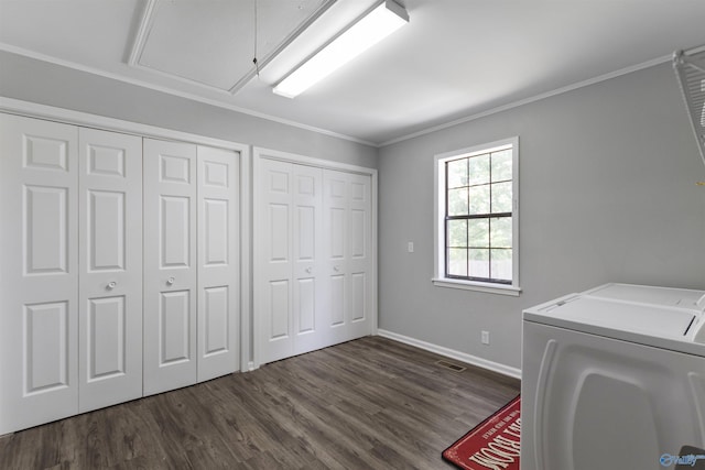 washroom with attic access, washing machine and clothes dryer, laundry area, visible vents, and dark wood-type flooring