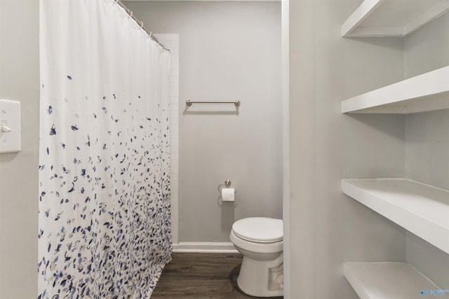 full bath with a shower with curtain, toilet, baseboards, and wood finished floors