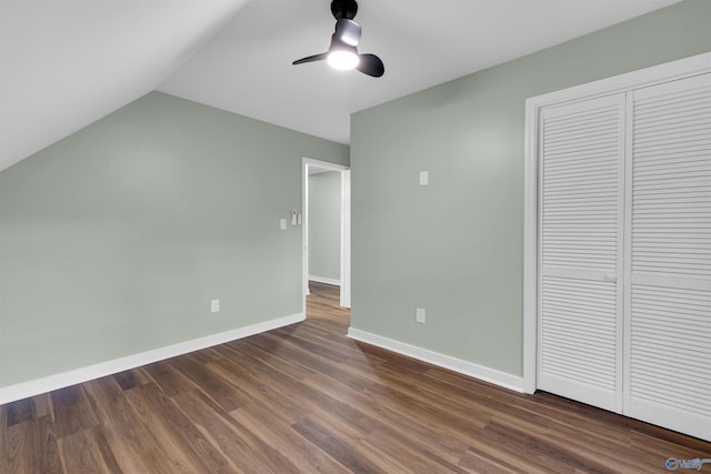 unfurnished bedroom featuring lofted ceiling, dark hardwood / wood-style floors, a closet, and ceiling fan