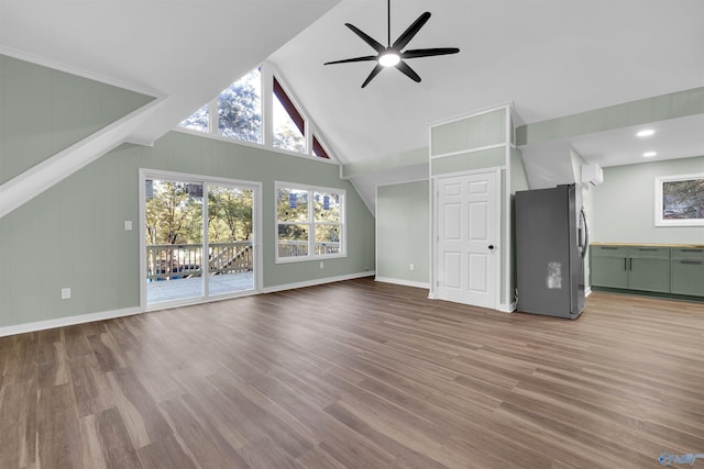 unfurnished living room featuring ceiling fan, high vaulted ceiling, and wood-type flooring