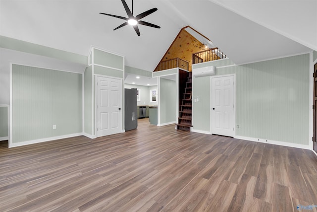 unfurnished living room with high vaulted ceiling, hardwood / wood-style flooring, a wall mounted AC, and ceiling fan