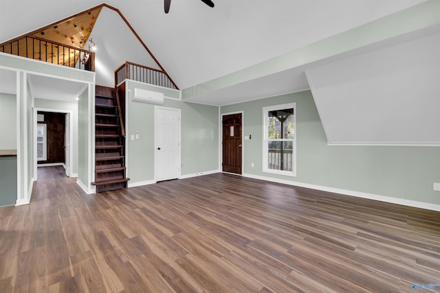 unfurnished living room with an AC wall unit, dark wood-type flooring, high vaulted ceiling, and ceiling fan