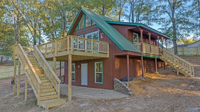 rear view of house with a wooden deck