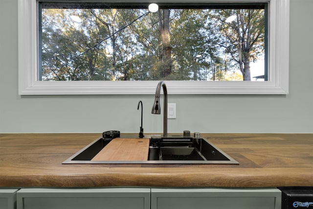 room details featuring green cabinetry and sink