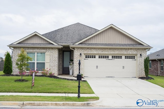 view of front of house with a garage and a front lawn