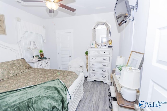 bedroom featuring ceiling fan and light hardwood / wood-style floors