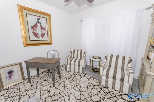 sitting room with light hardwood / wood-style floors and ceiling fan