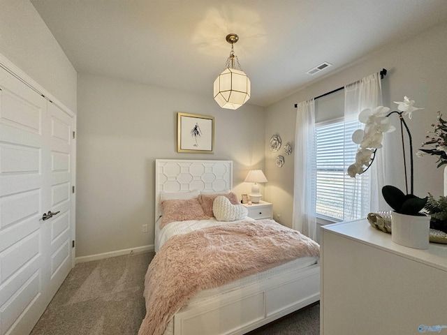 carpeted bedroom featuring visible vents and baseboards