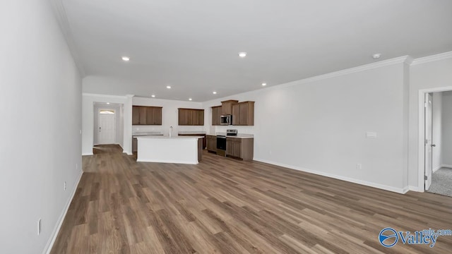 unfurnished living room with dark hardwood / wood-style flooring, crown molding, and sink