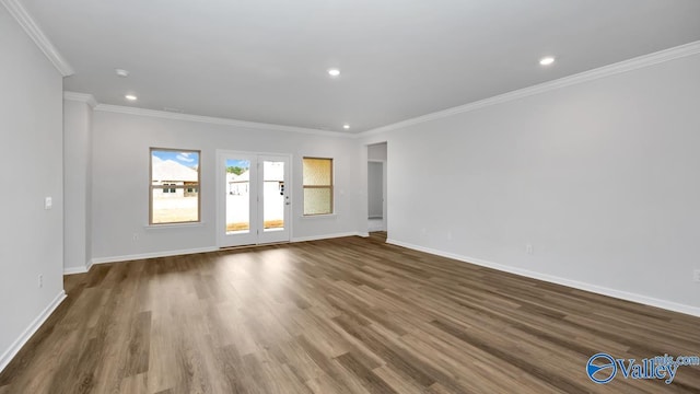 empty room featuring ornamental molding and dark wood-type flooring