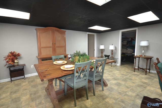 dining room featuring a drop ceiling