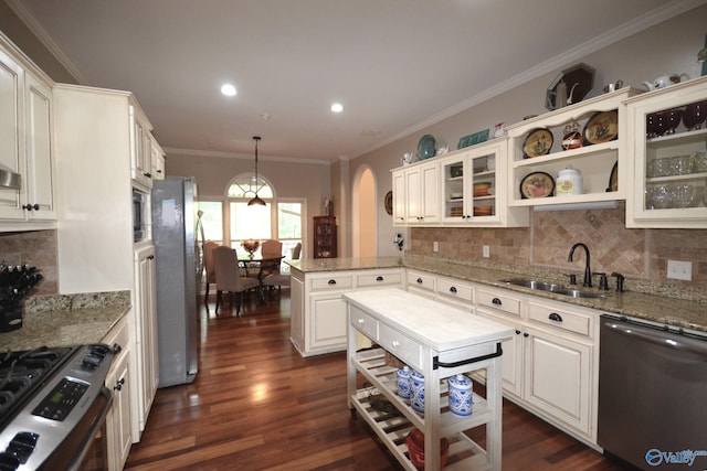 kitchen with pendant lighting, dark hardwood / wood-style floors, white cabinetry, and appliances with stainless steel finishes