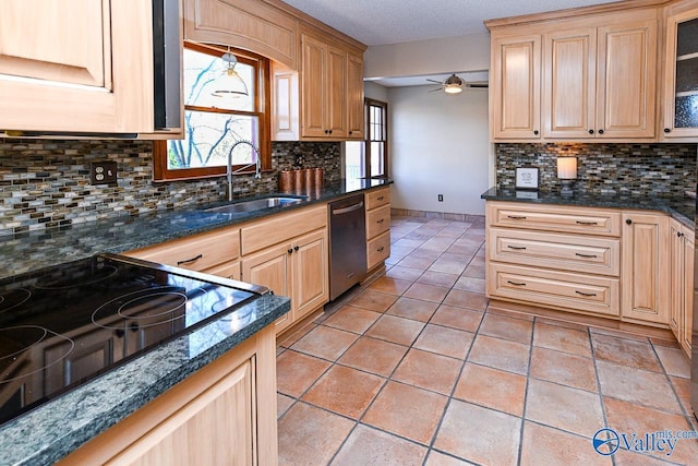 kitchen with stainless steel dishwasher, backsplash, cooktop, and a sink