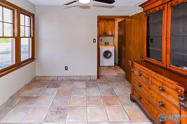 washroom featuring baseboards, washer / clothes dryer, cabinet space, and a ceiling fan