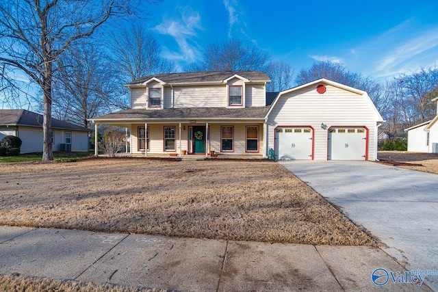 view of front of house with aphalt driveway, an attached garage, covered porch, a gambrel roof, and roof with shingles