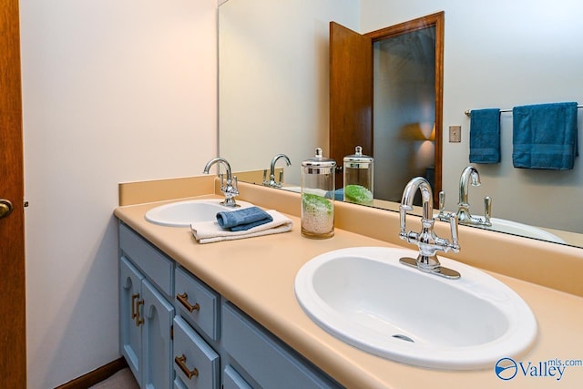 bathroom with double vanity and a sink