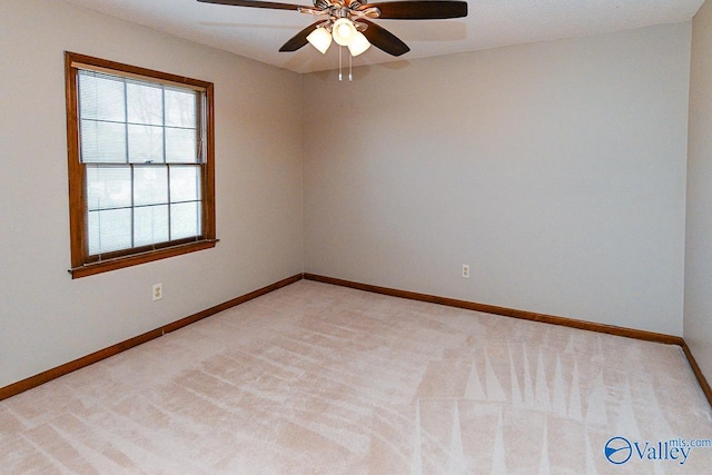 unfurnished room with ceiling fan, baseboards, and light colored carpet