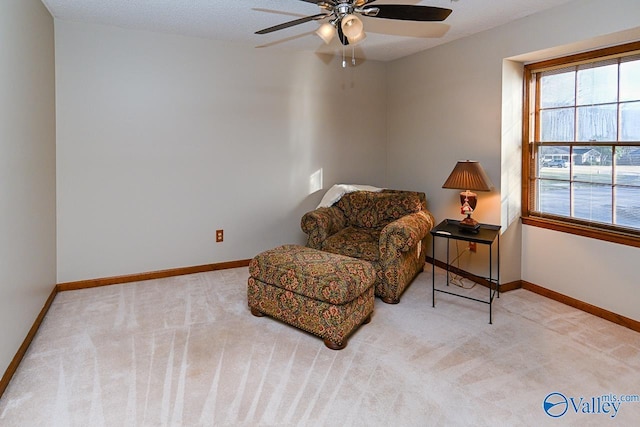 sitting room featuring carpet floors, ceiling fan, a textured ceiling, and baseboards