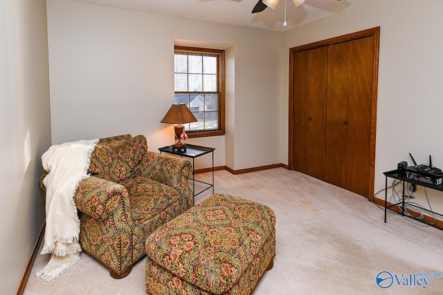 sitting room with carpet, a textured ceiling, baseboards, and a ceiling fan