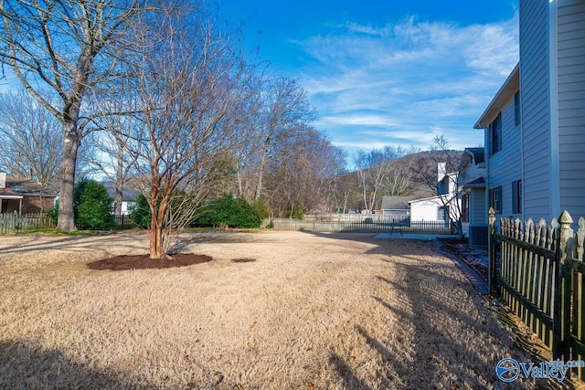 view of street with driveway, a gated entry, and a mountain view