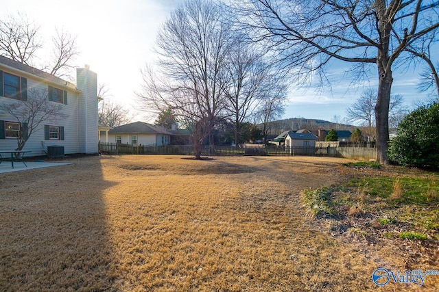 view of yard with central air condition unit, fence, and a patio