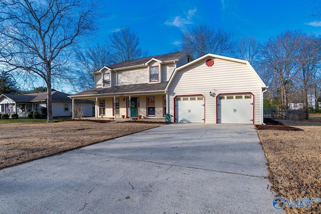 view of front of house with a garage, covered porch, driveway, and a gambrel roof