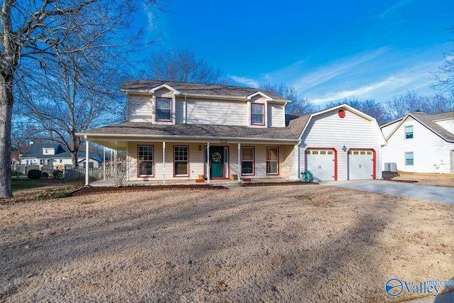 view of front facade with covered porch, concrete driveway, an attached garage, and fence