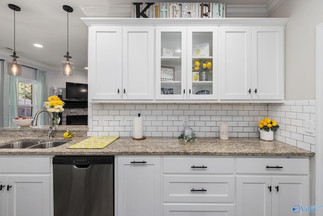 kitchen featuring sink, ornamental molding, stainless steel dishwasher, white cabinetry, and decorative light fixtures