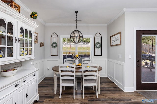 dining room with a wealth of natural light, dark hardwood / wood-style floors, and ornamental molding