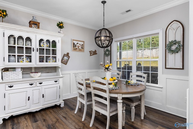 dining space with ornamental molding, dark hardwood / wood-style floors, and an inviting chandelier