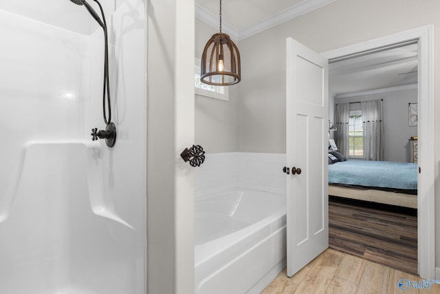 bathroom with a washtub, wood-type flooring, and crown molding