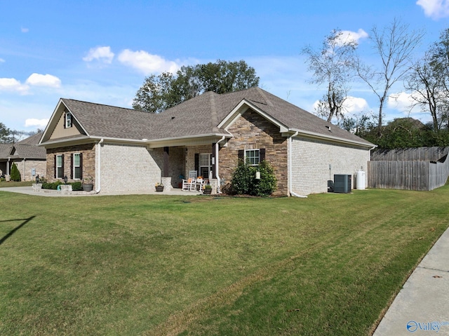 view of front of property featuring central AC unit, a front yard, and a patio